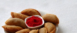 Gujia and many more sweets are prepared as a food on Holi.